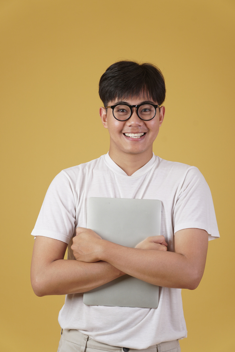 Smiling Asian Man Nerd Student Holding Laptop